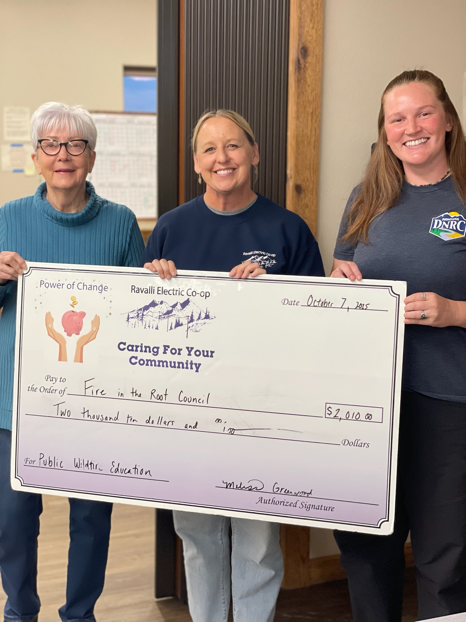 Fire In The Root Receiving Grant Check from Ravalli County Electric